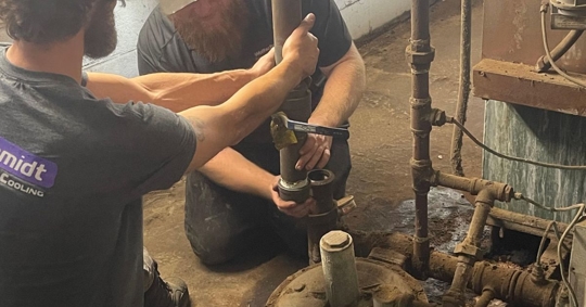 men working on plumbing system